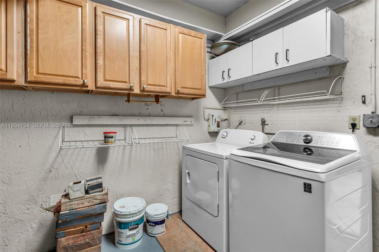 11319 Southwest 73rd Lane Miami, FL 33173 - Photo 25 of 43 a kitchen with a sink a stove and cabinets