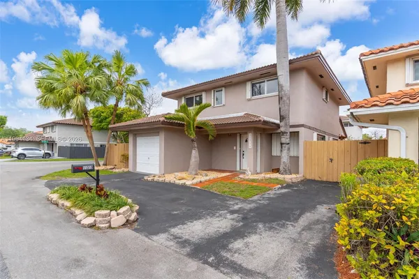 a front view of a house with a yard and a garage