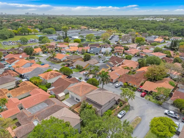 an aerial view of residential houses with outdoor space and river