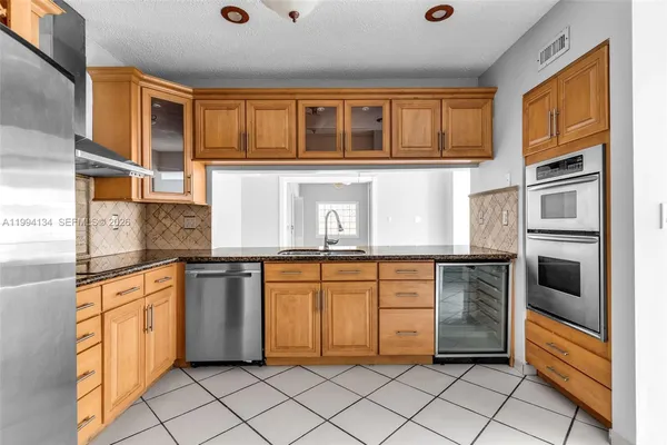 a kitchen with stainless steel appliances granite countertop a stove top oven