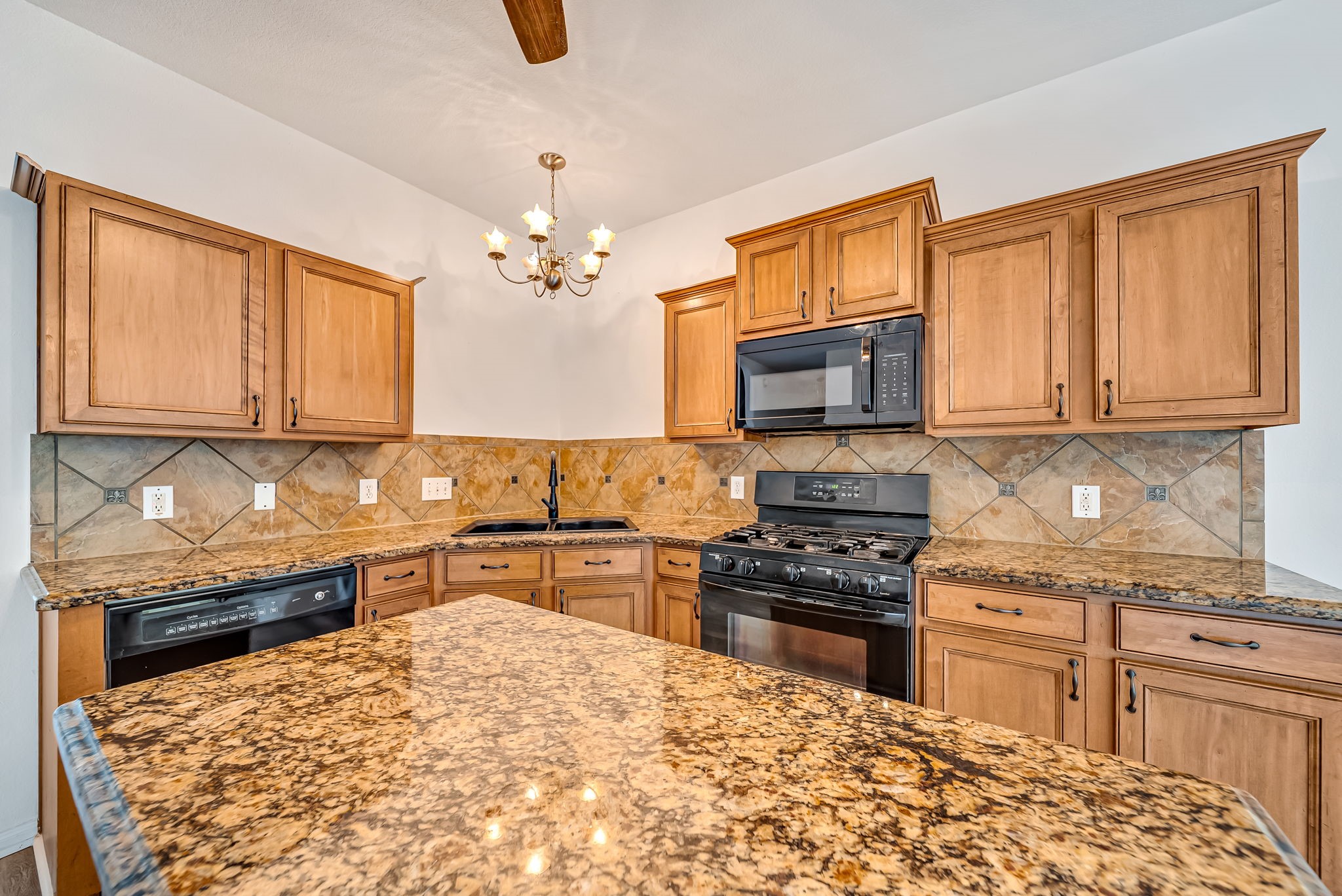 23526 Whispering Maple Drive Spring, TX 77373 - Photo 9 of 26 a kitchen with stainless steel appliances granite countertop a stove top oven a sink dishwasher and cabinets with wooden floor