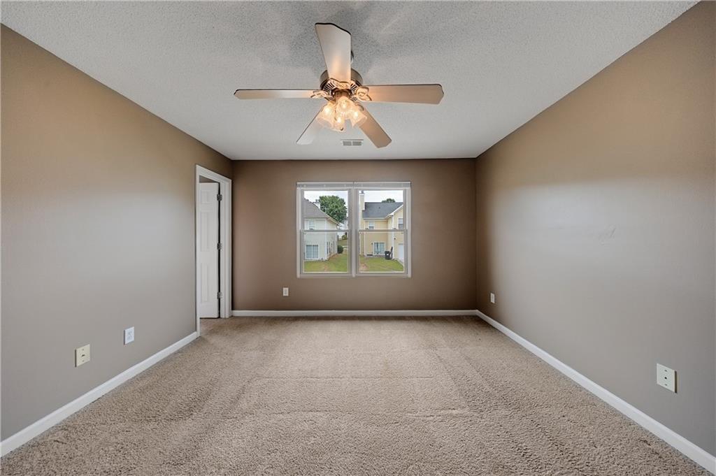 4203 Legacy Square Atlanta, GA 30349 - Photo 23 of 35 an empty room with windows and fan