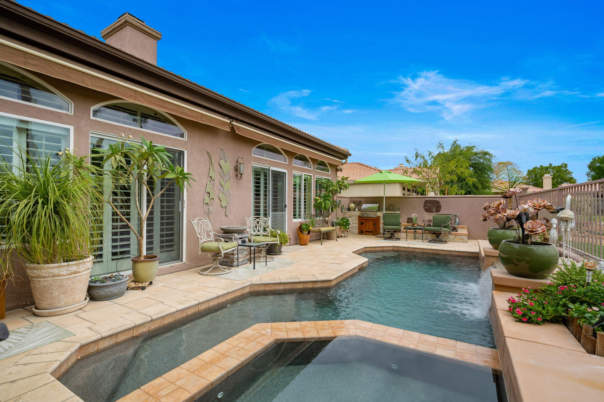 48908 Heifitz Drive Indio, CA 92201 - Photo 11 of 42 a view of a backyard with swimming pool and sitting area