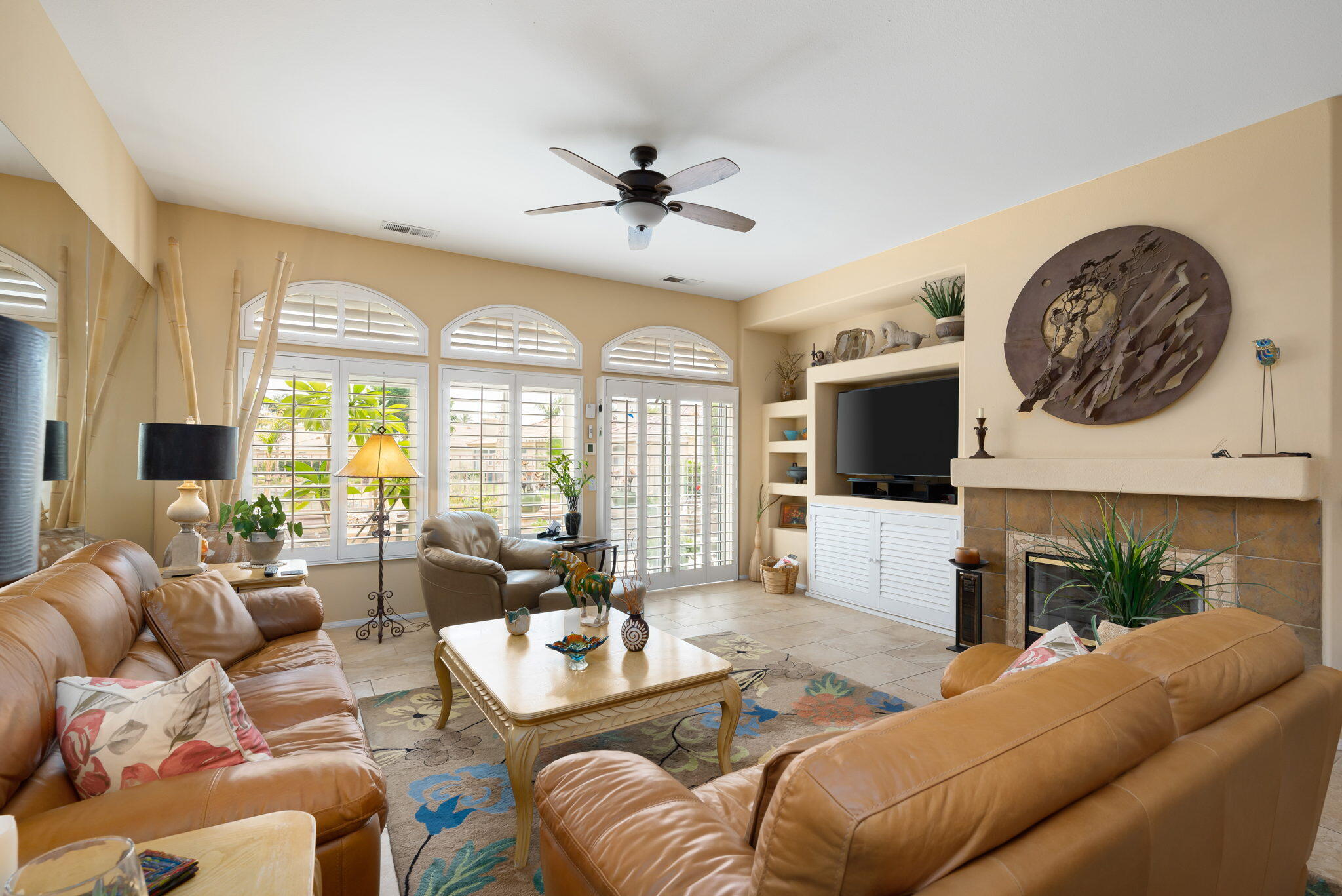 48908 Heifitz Drive Indio, CA 92201 - Photo 18 of 42 a living room with furniture a fireplace and a flat screen tv