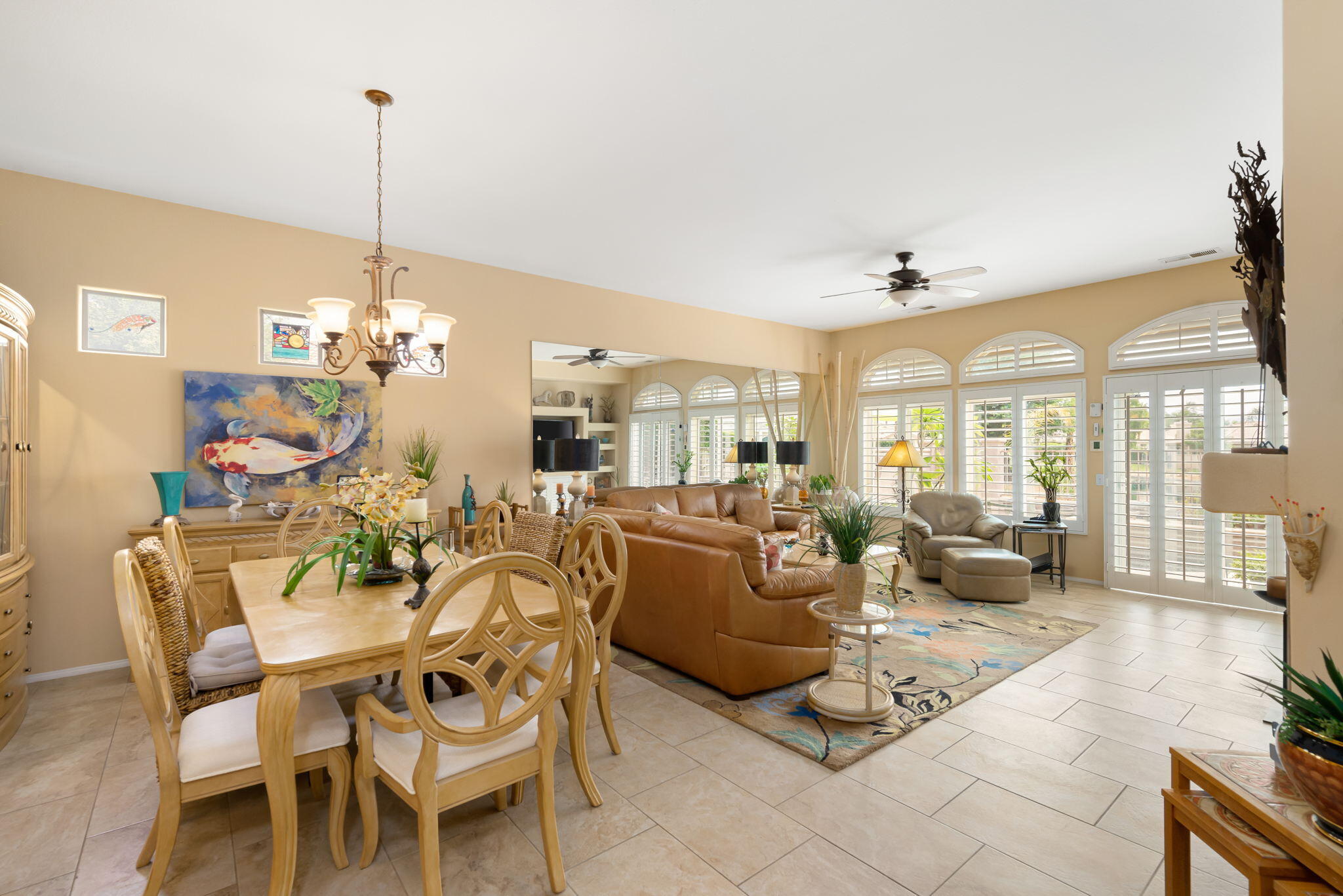 48908 Heifitz Drive Indio, CA 92201 - Photo 19 of 42 a living room with furniture a chandelier and a chandelier