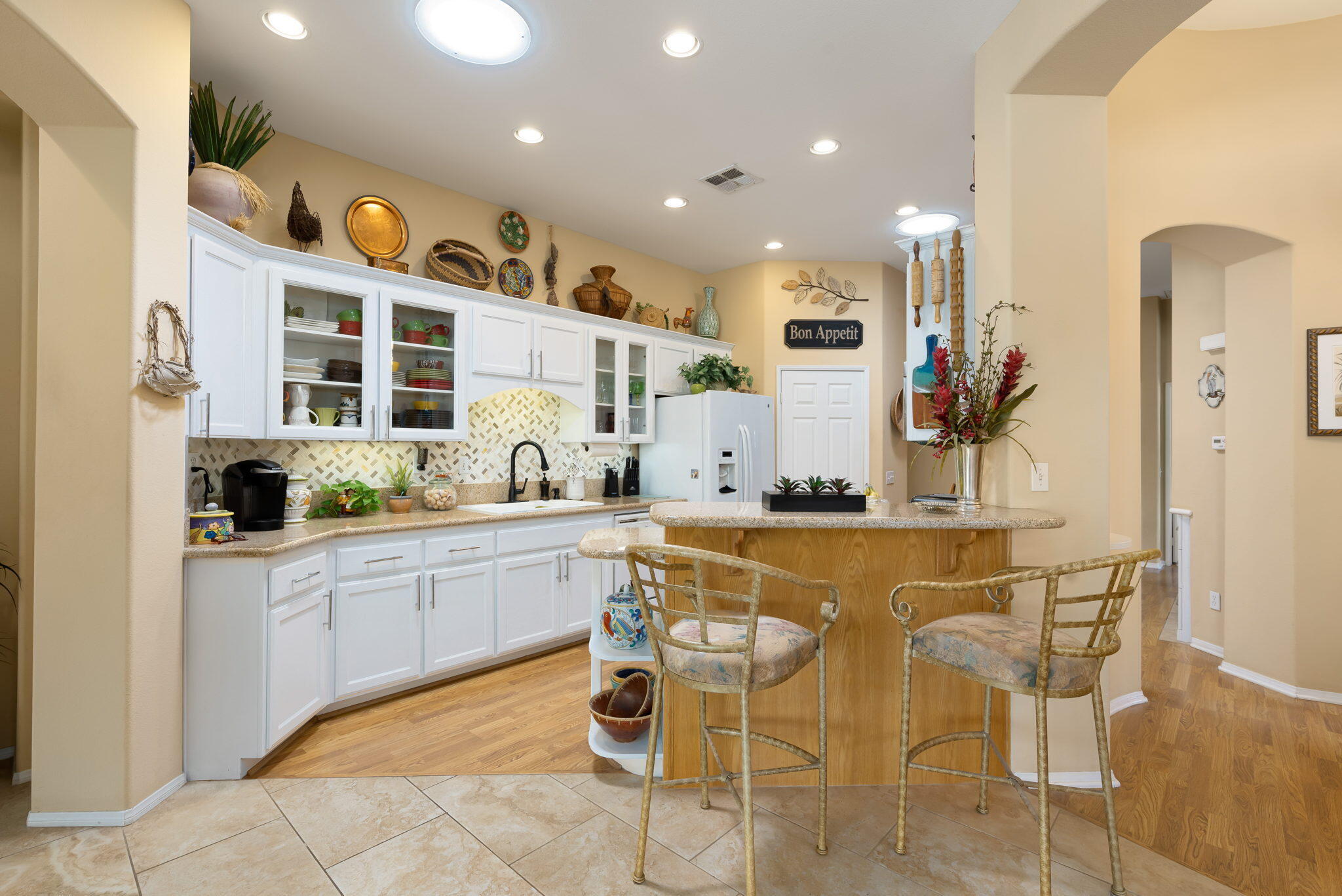 48908 Heifitz Drive Indio, CA 92201 - Photo 21 of 42 a kitchen with stainless steel appliances kitchen island granite countertop a sink and cabinets