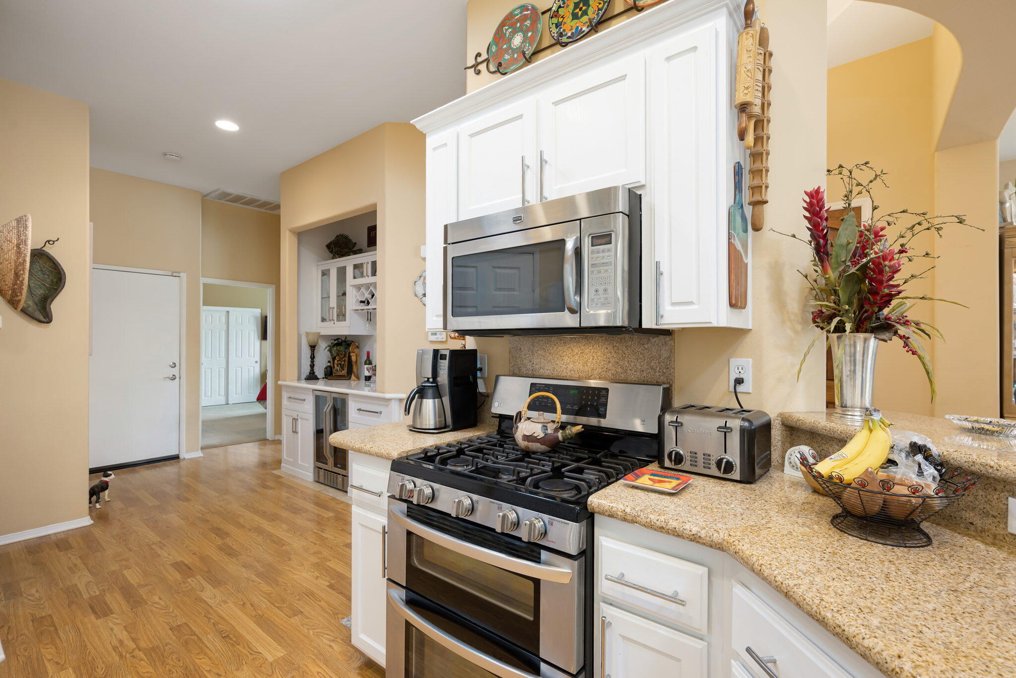 48908 Heifitz Drive Indio, CA 92201 - Photo 25 of 42 a kitchen with stainless steel appliances granite countertop a stove a sink and a microwave
