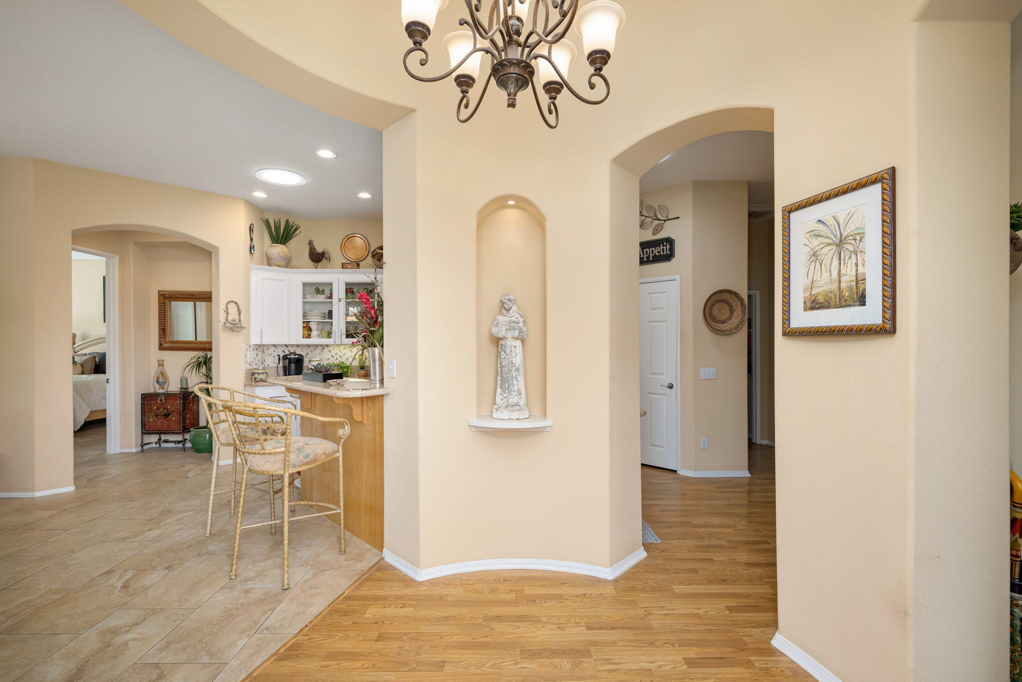 48908 Heifitz Drive Indio, CA 92201 - Photo 28 of 42 a view of a dining room with furniture a chandelier and wooden floor