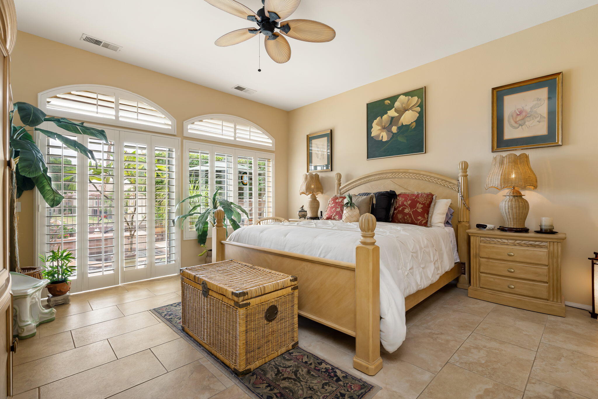 48908 Heifitz Drive Indio, CA 92201 - Photo 29 of 42 a bedroom with a large bed and a chandelier