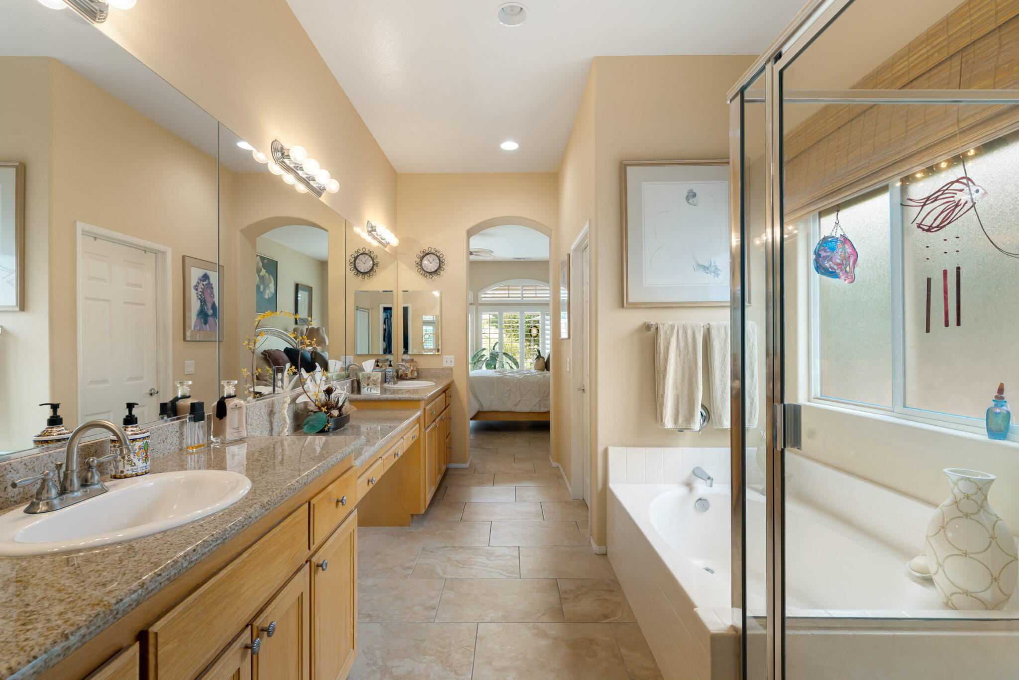 48908 Heifitz Drive Indio, CA 92201 - Photo 31 of 42 a en suite bathroom with a double vanity sink and mirror