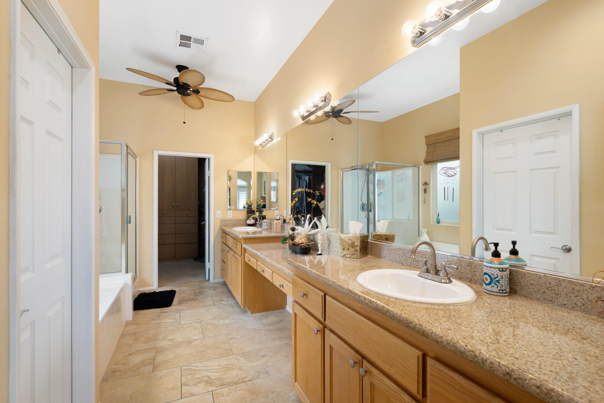 48908 Heifitz Drive Indio, CA 92201 - Photo 32 of 42 a bathroom with a sink double vanity granite tub shower and a mirror