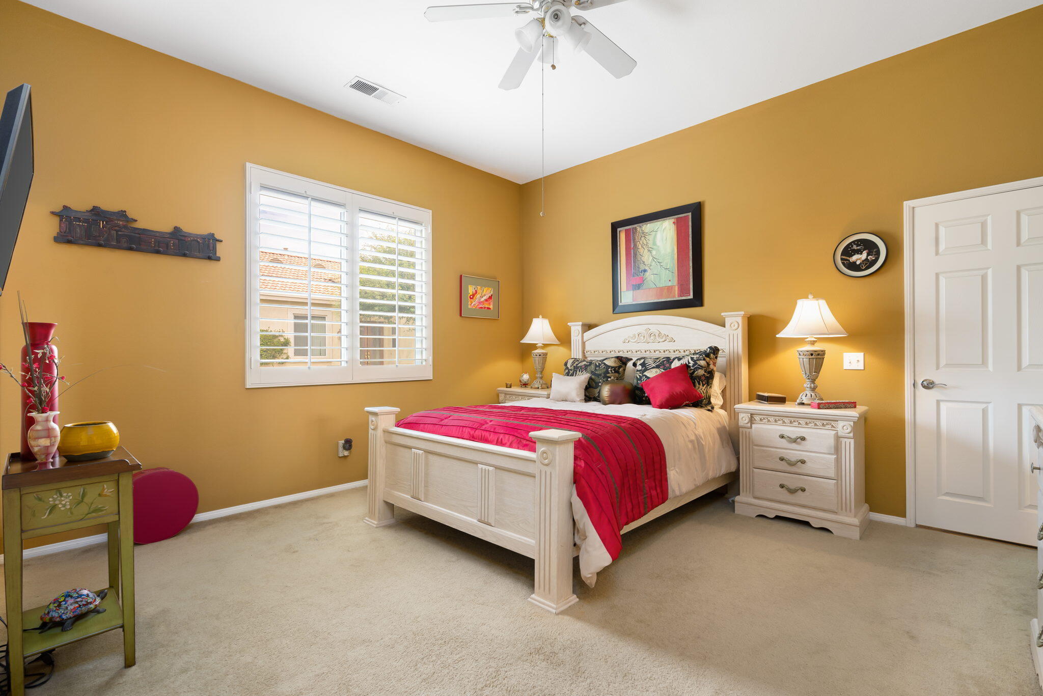 48908 Heifitz Drive Indio, CA 92201 - Photo 33 of 42 a spacious bedroom with a bed and a chandelier