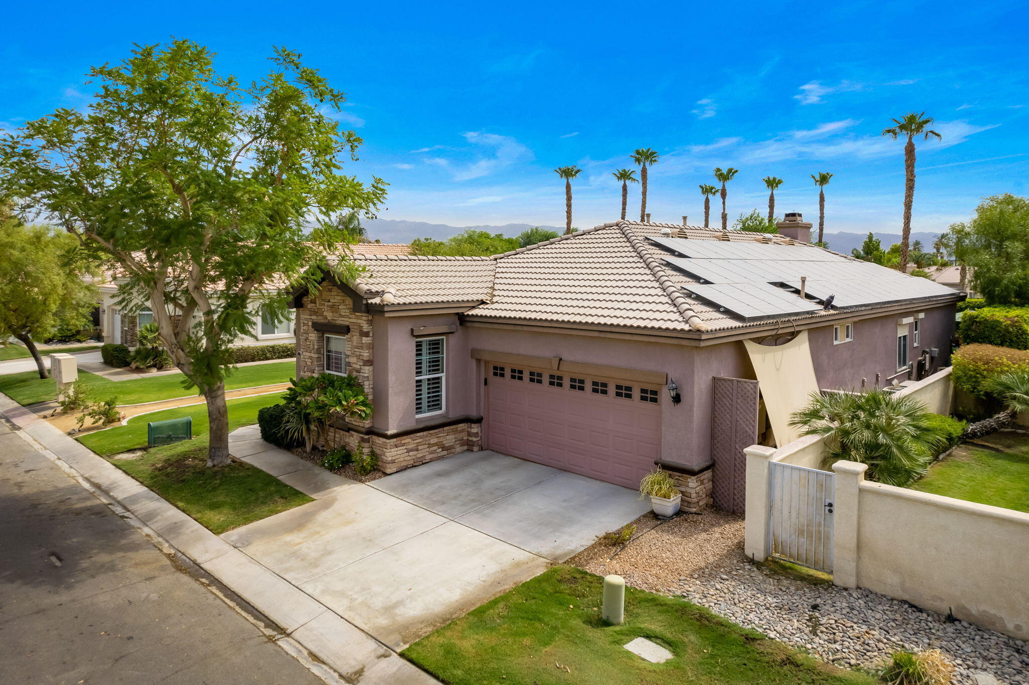 48908 Heifitz Drive Indio, CA 92201 - Photo 4 of 42 a view of a house with a yard and a garage