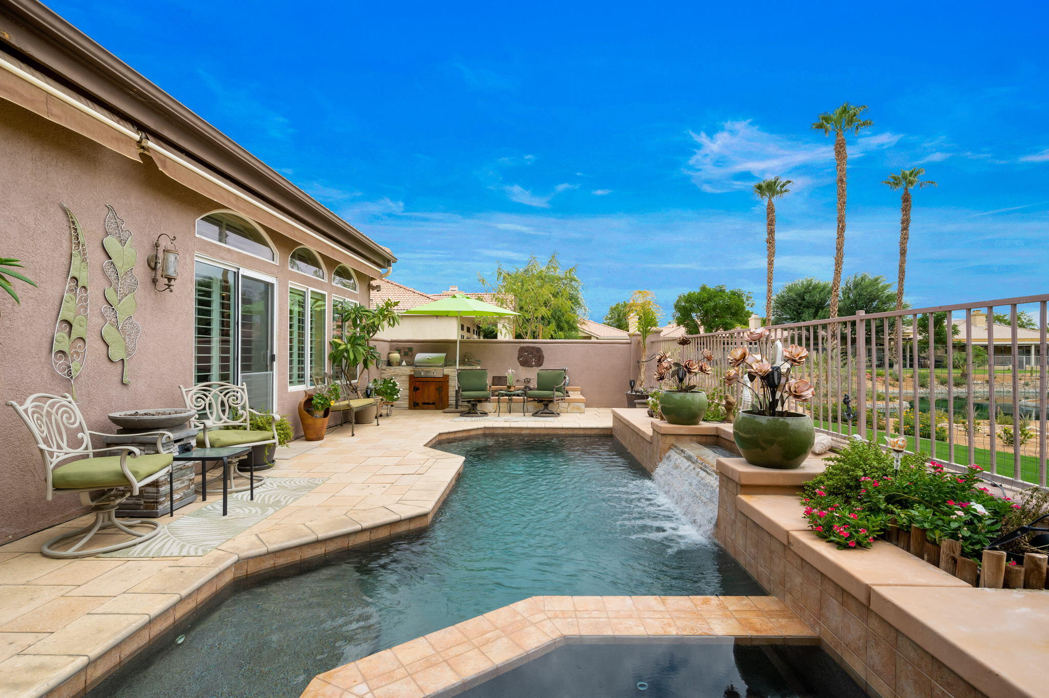 48908 Heifitz Drive Indio, CA 92201 - Photo 8 of 42 a view of a swimming pool with chairs