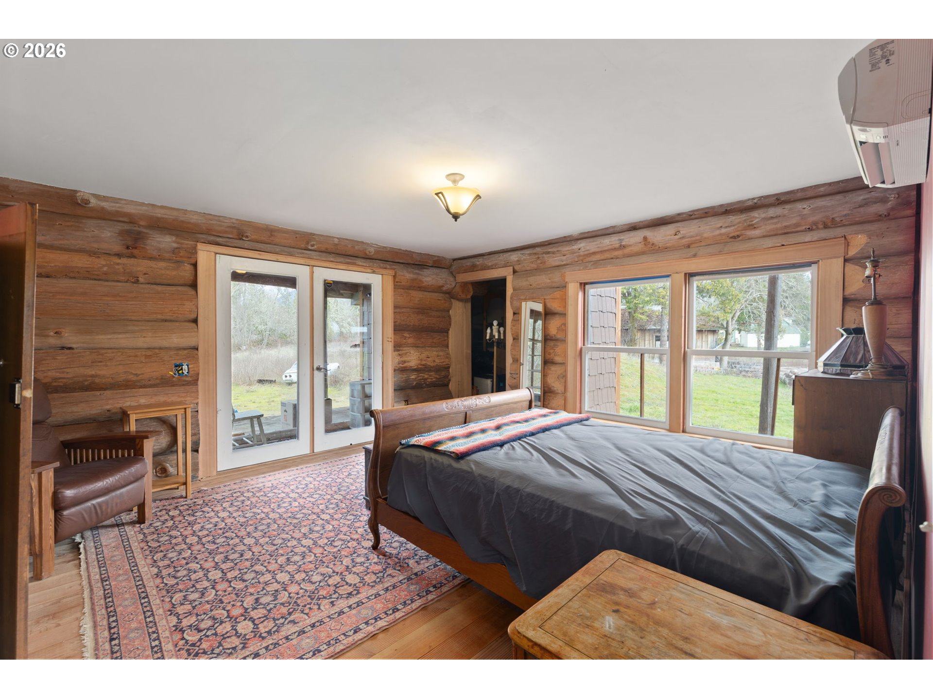 4420 Holland Loop Road Cave Junction, OR 97523 - Photo 15 of 46 a living room with a bed furniture and a large window