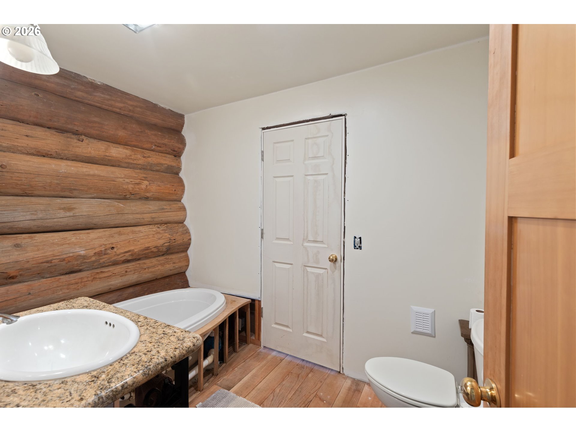 4420 Holland Loop Road Cave Junction, OR 97523 - Photo 17 of 46 a bathroom with a toilet a sink and bathtub