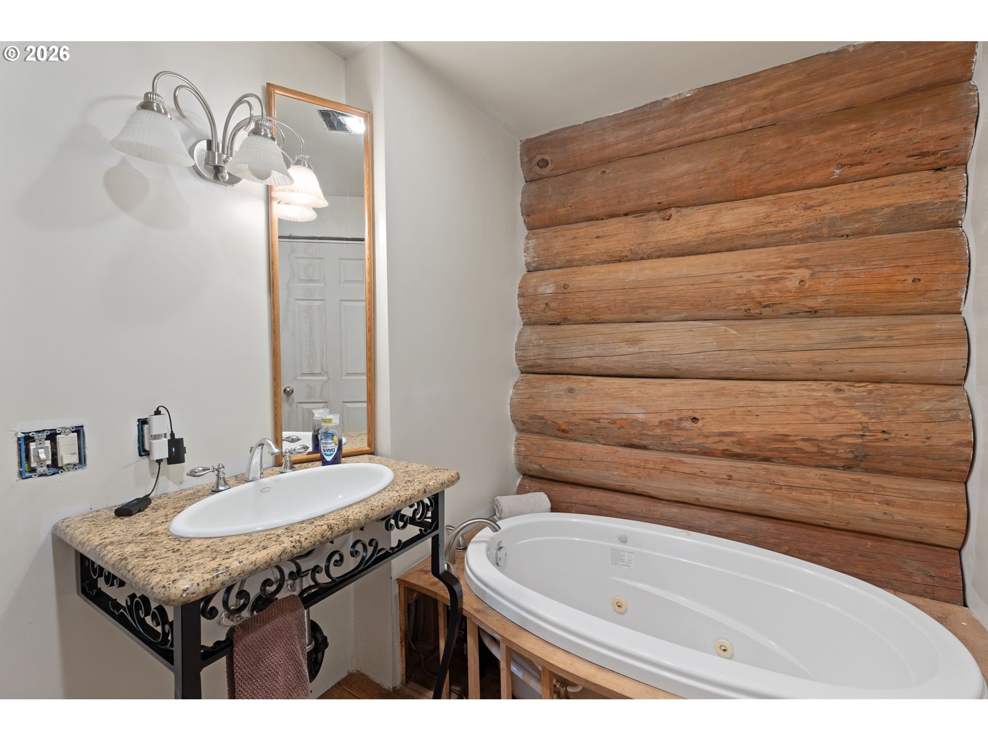 4420 Holland Loop Road Cave Junction, OR 97523 - Photo 18 of 46 a bathroom with a granite countertop sink and a mirror