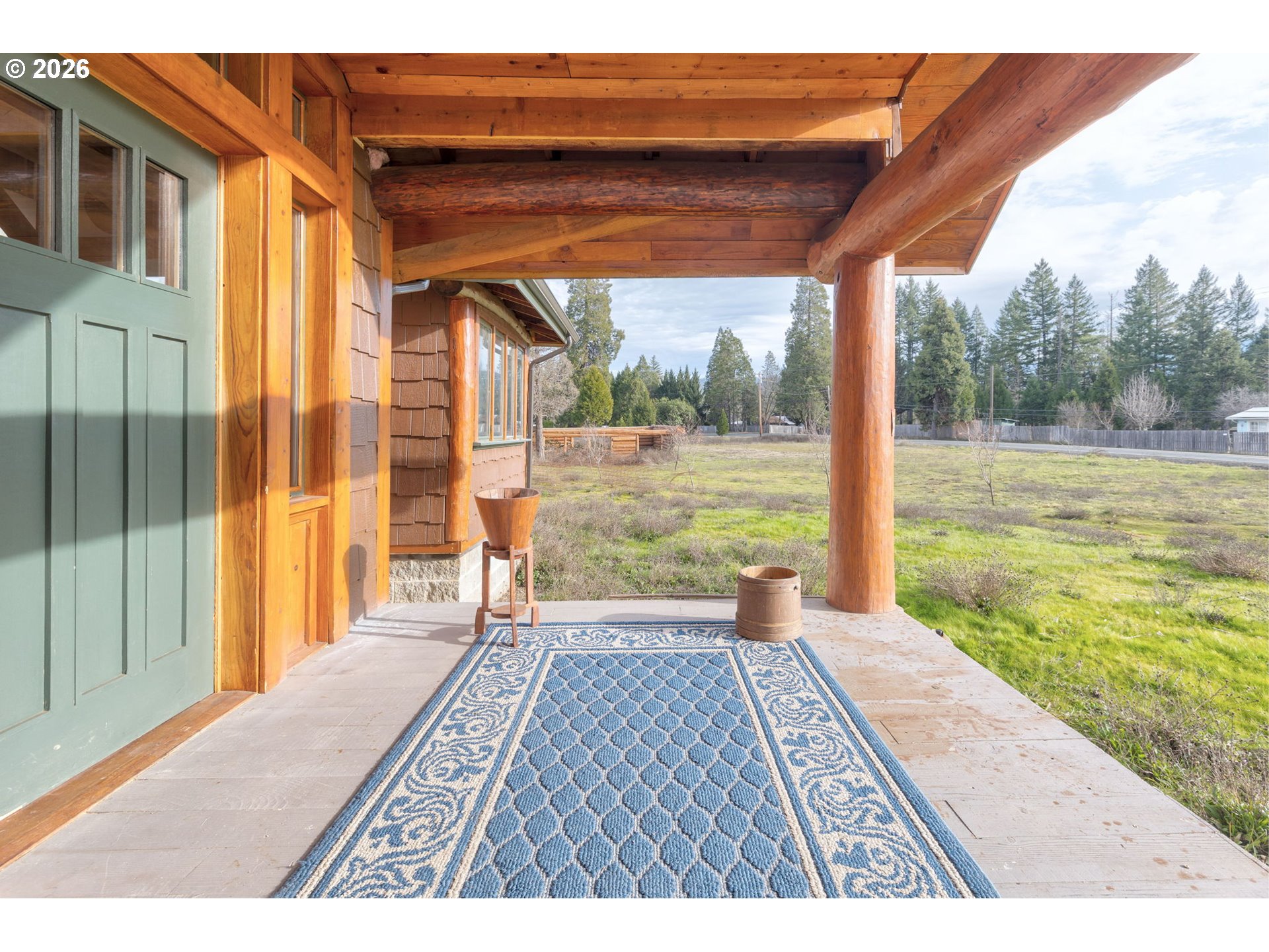 4420 Holland Loop Road Cave Junction, OR 97523 - Photo 4 of 46 a view of a room with wooden floor and a yard