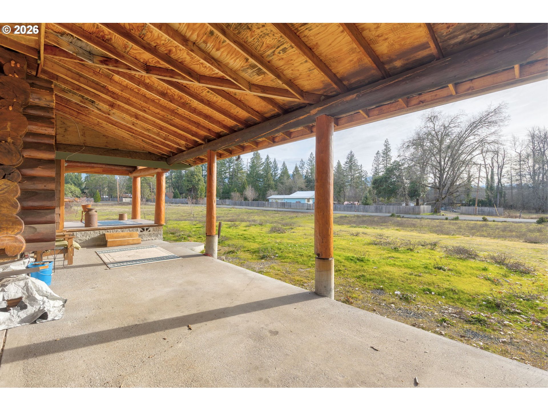 4420 Holland Loop Road Cave Junction, OR 97523 - Photo 5 of 46 a view of a room with floor to ceiling windows and pool table and chairs