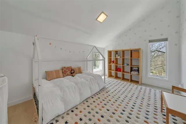 a bedroom with furniture and a window