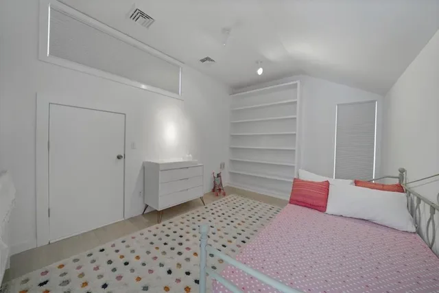 a bedroom with a bed and a cabinets