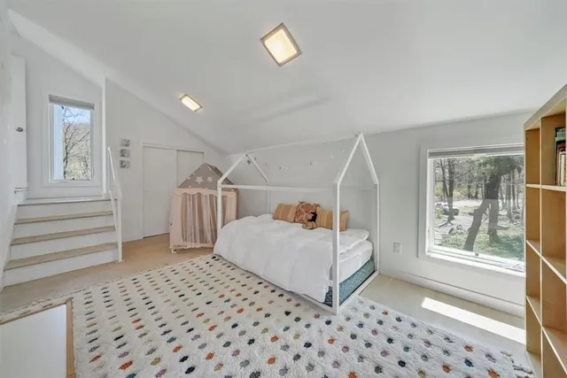 a bedroom with a bed and a window