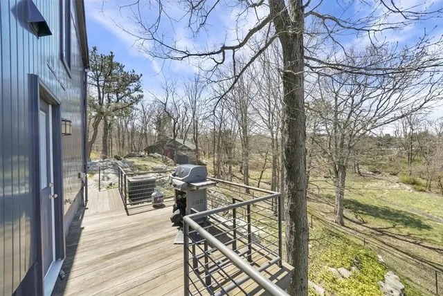 a view of balcony with chairs and wooden floor