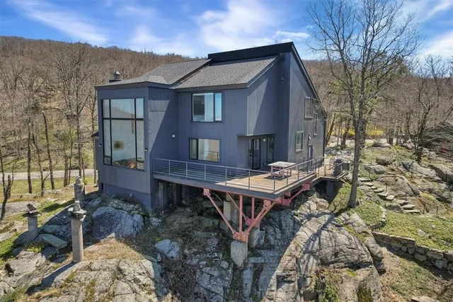 a backyard of a house with table and chairs