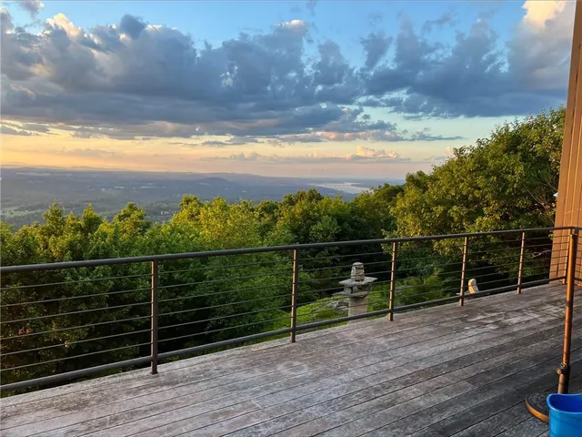 a view of a terrace with wooden floor and fence