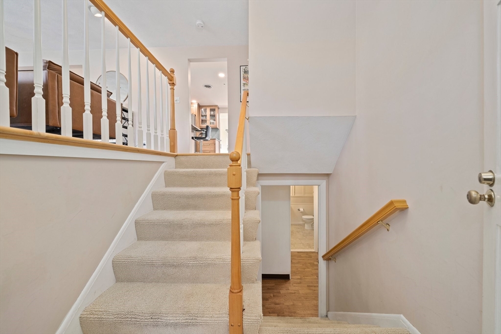 20 Condor Road Sharon, MA 02067 - Photo 25 of 41 a view of staircase with lots of frames on wall and a window