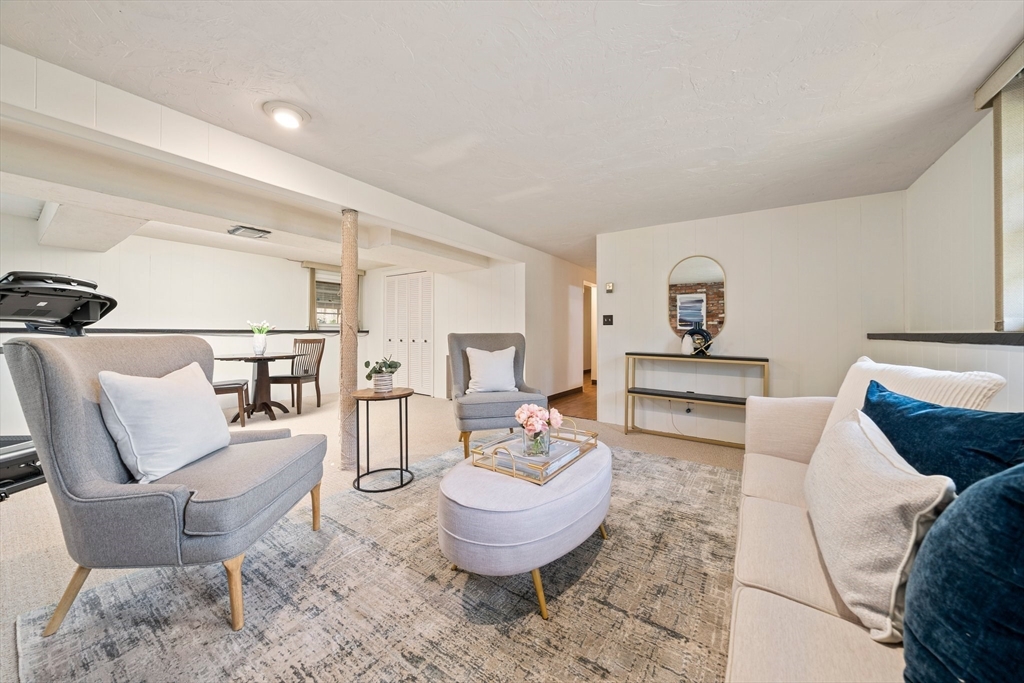 20 Condor Road Sharon, MA 02067 - Photo 27 of 41 a living room with furniture and a chair