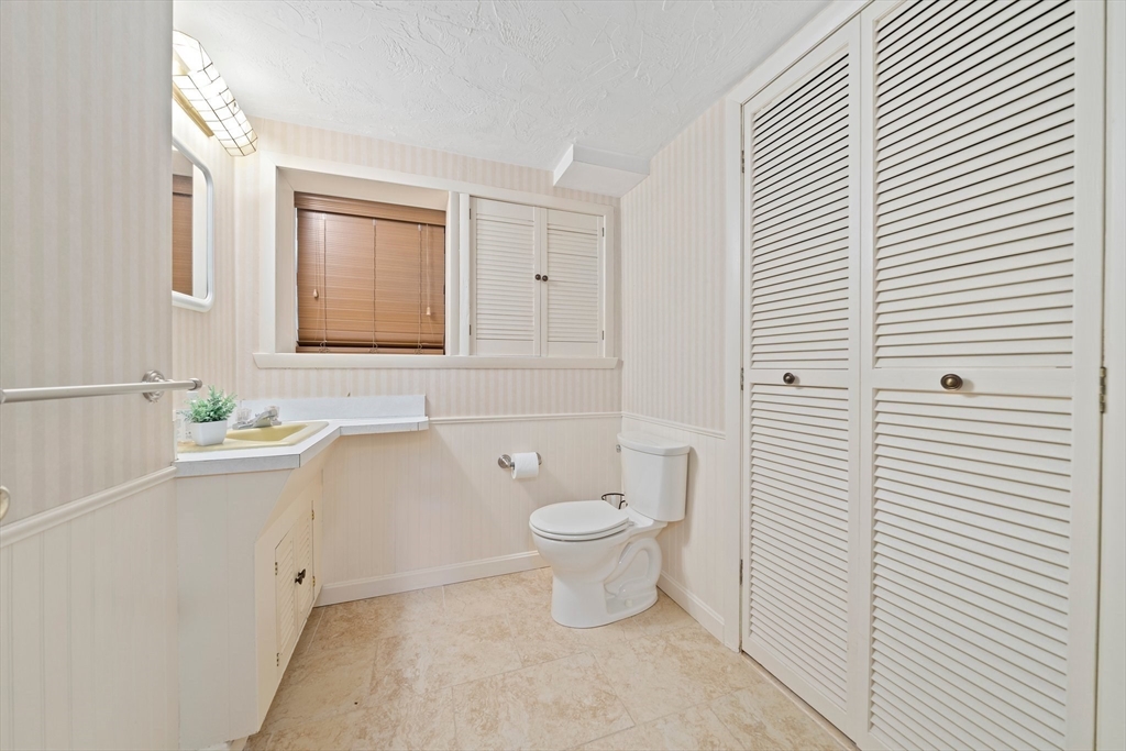 20 Condor Road Sharon, MA 02067 - Photo 29 of 41 a bathroom with a toilet a sink and mirror