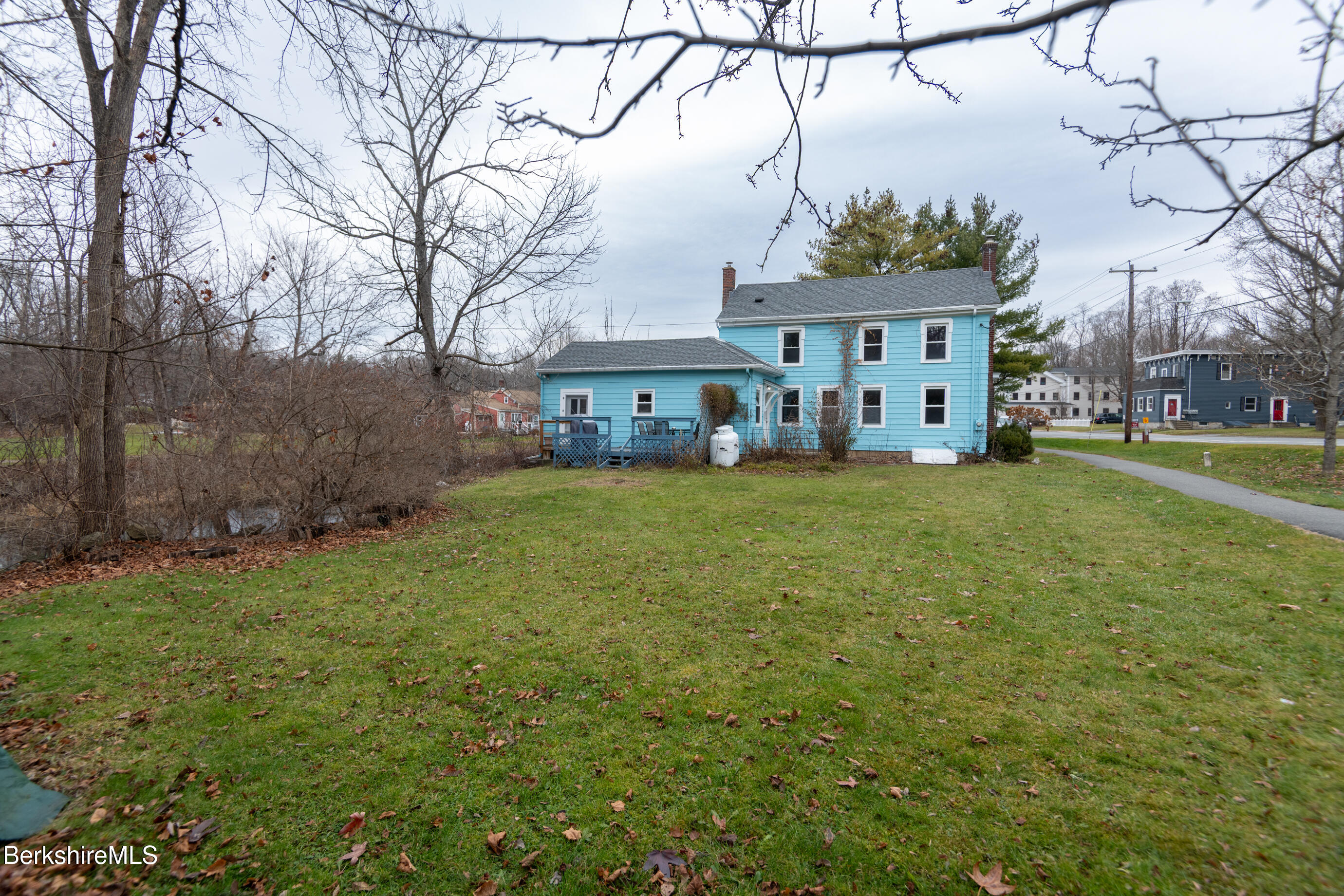 44 Main Street West Stockbridge, MA 01266 - Photo 24 of 28 a view of a white house with a big yard and large trees