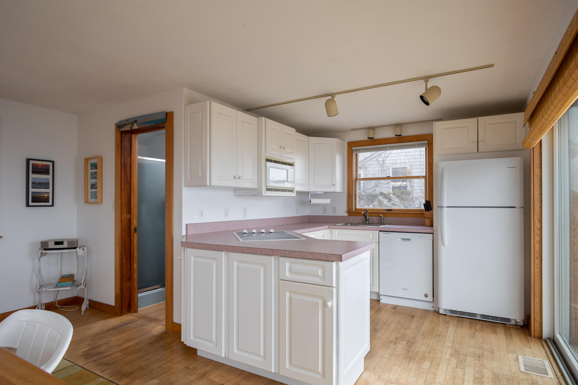 35 Bayberry Lane Eastham, MA 02642 - Photo 11 of 42 a kitchen with a refrigerator sink and cabinets