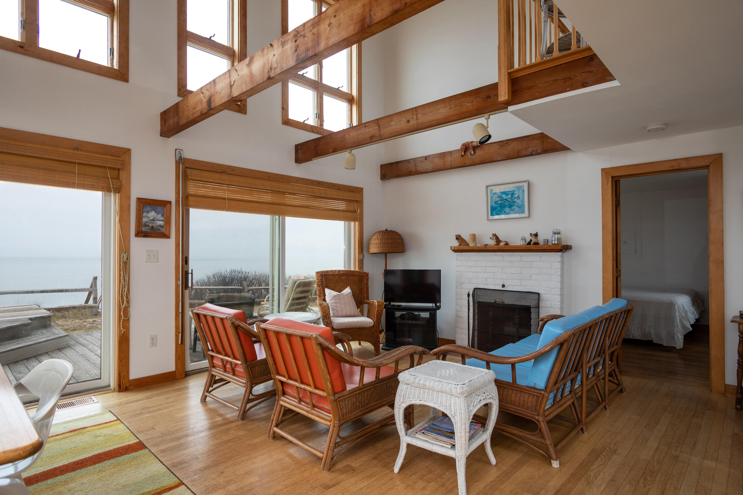 35 Bayberry Lane Eastham, MA 02642 - Photo 16 of 42 a dining room with furniture a fireplace and wooden floor