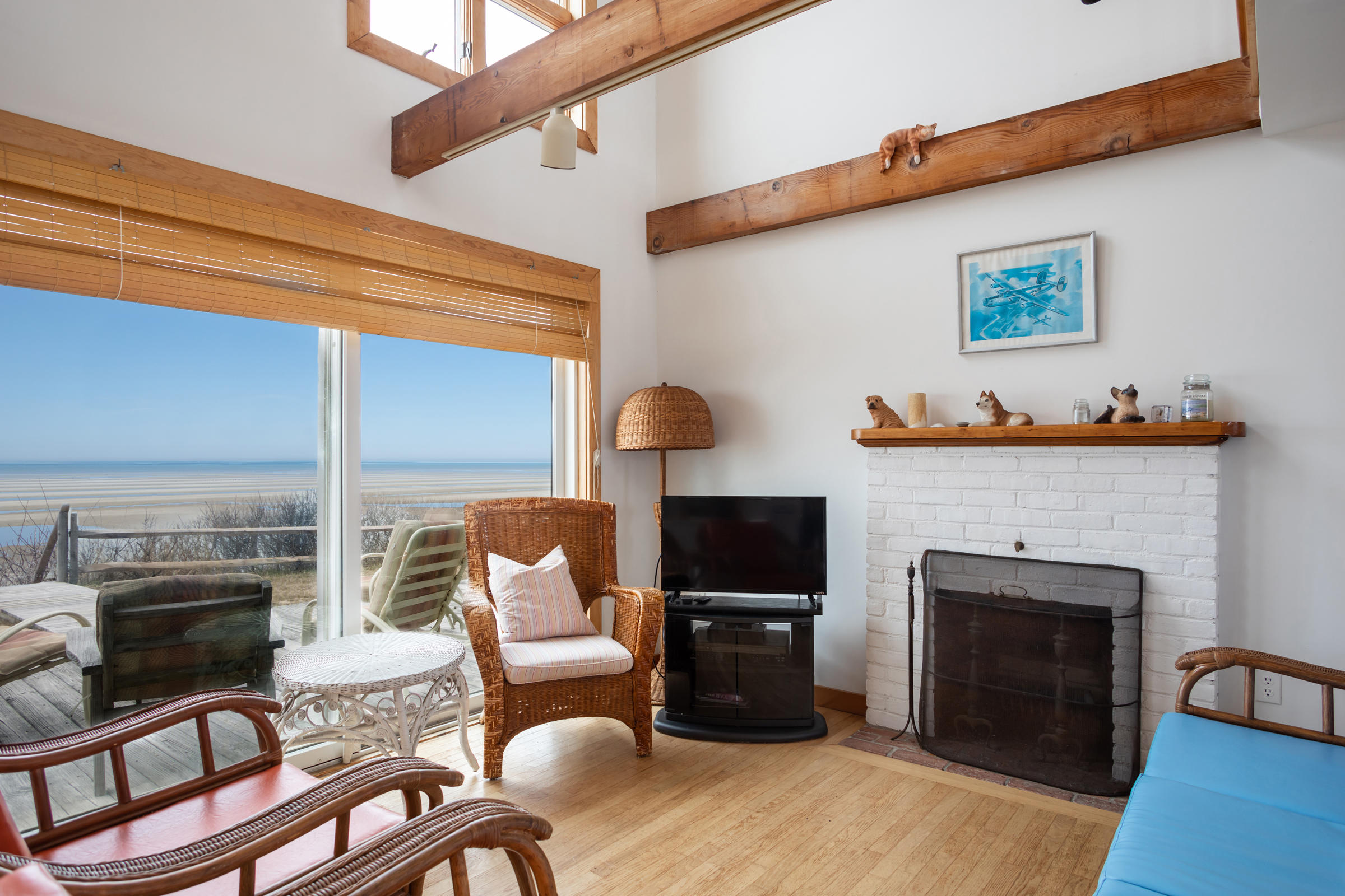35 Bayberry Lane Eastham, MA 02642 - Photo 17 of 42 a living room with furniture a fireplace and a flat screen tv