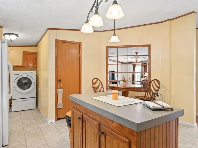 a kitchen with a sink stove and a refrigerator