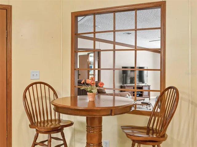 a dining room with furniture and a window