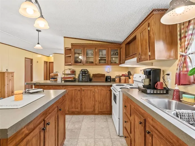 a kitchen with stainless steel appliances granite countertop a stove and a sink