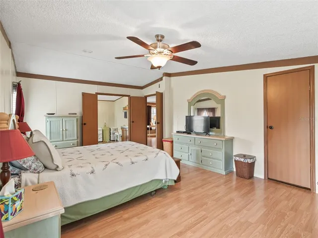 a bedroom with a bed and ceiling fan