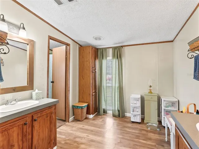 a spacious bathroom with a double vanity sink and a mirror