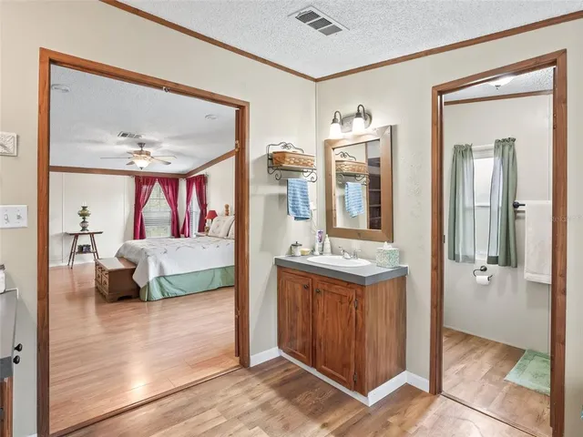 a bedroom with furniture and a mirror