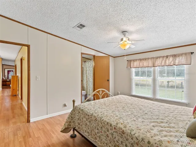 a bedroom with a bed and a large window