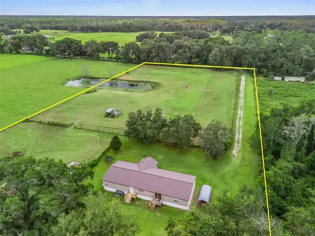a view of a field with sitting area