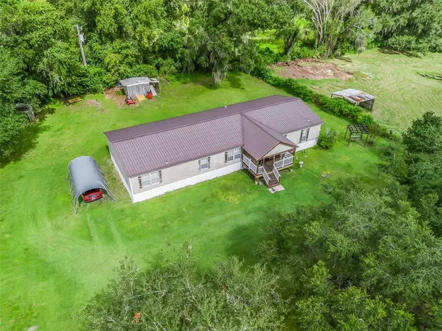 a aerial view of a house with backyard