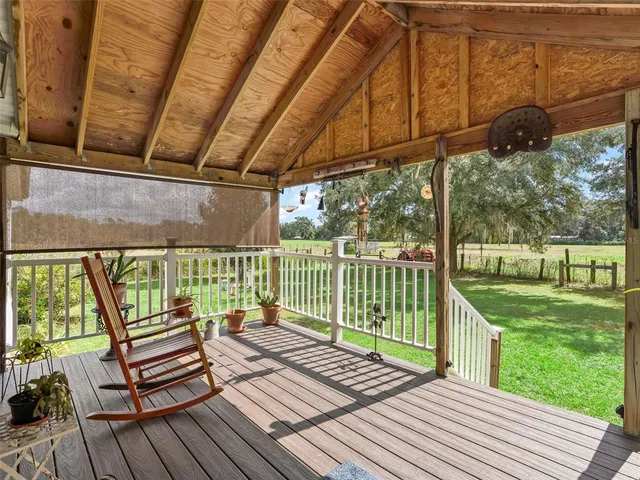a view of a wooden deck with a yard