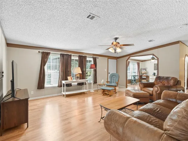 a living room with furniture and large windows