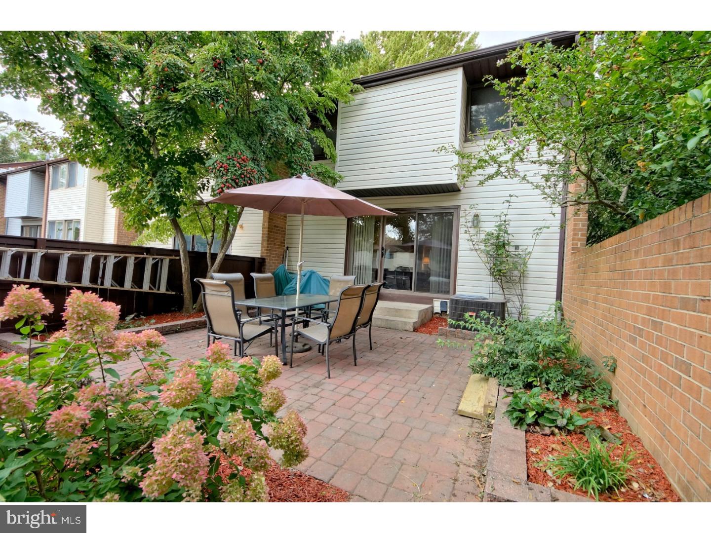 251 Probasco Road East Windsor, NJ 08520 - Photo 21 of 25 a view of a patio with table and chairs under an umbrella