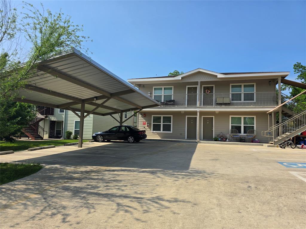 702 West 6th Street, Unit B Taylor, TX 76574 - Photo 1 of 1 View of front of home with stairway and covered porch