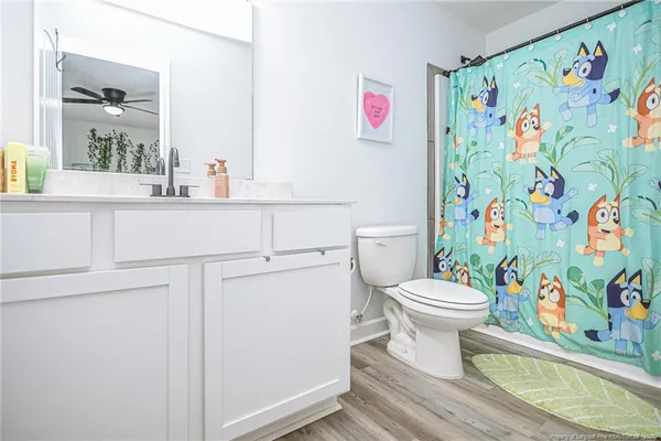 a white toilet sitting next to a bathroom sink